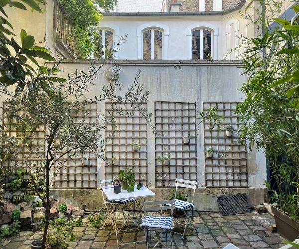 Cour intérieure avec végétation grimpante et treillage à Paris